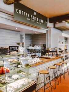 The Secret to Moist and Fluffy Cakes Inviting indoor scene of a bakery cafe with pastries and seating.